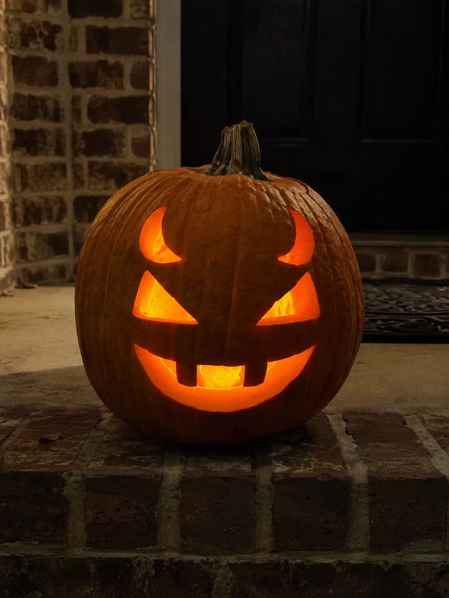 Curved Horn Devil Pumpkin on a Brick Doorstep