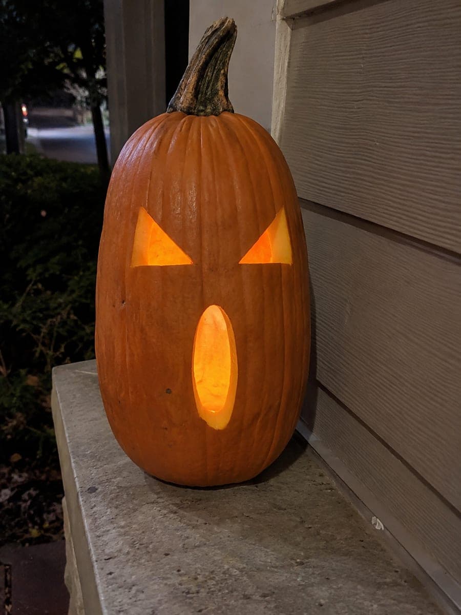 Diagonal-Eyed Skinny Pumpkin on a Narrow Porch Ledge