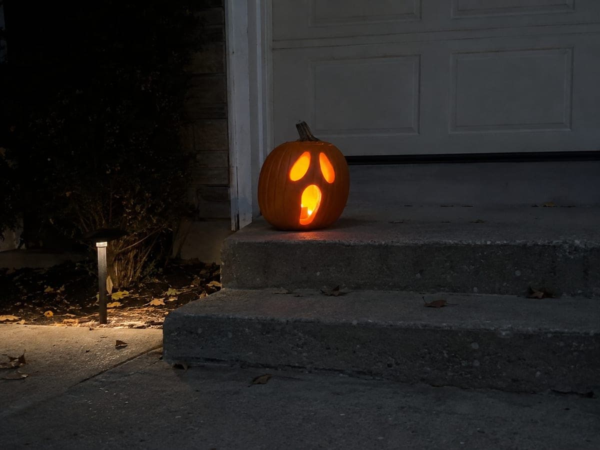 Drooping Eyes Screaming Face Pumpkin Glowing in Darkness