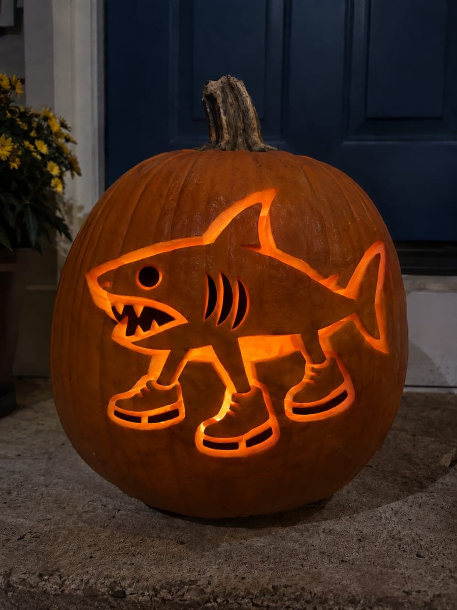 Gill-Cut Tralalero Tralala Pumpkin on a Dim Porch