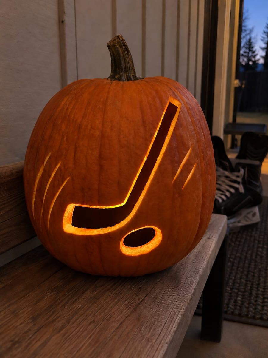 Hockey Stick and Puck Pumpkin Beside Skates