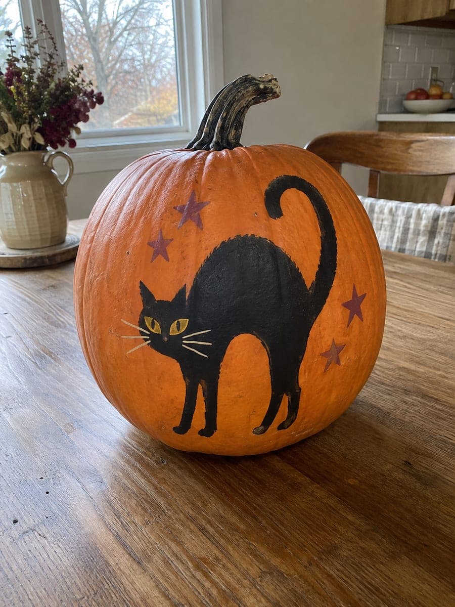 Painted Arch-Backed Black Cat with Mustard Eyes on Pumpkin
