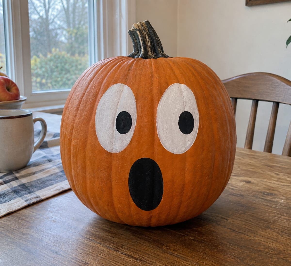 Painted Creepy Pumpkin With White Eyes and Black Mouth