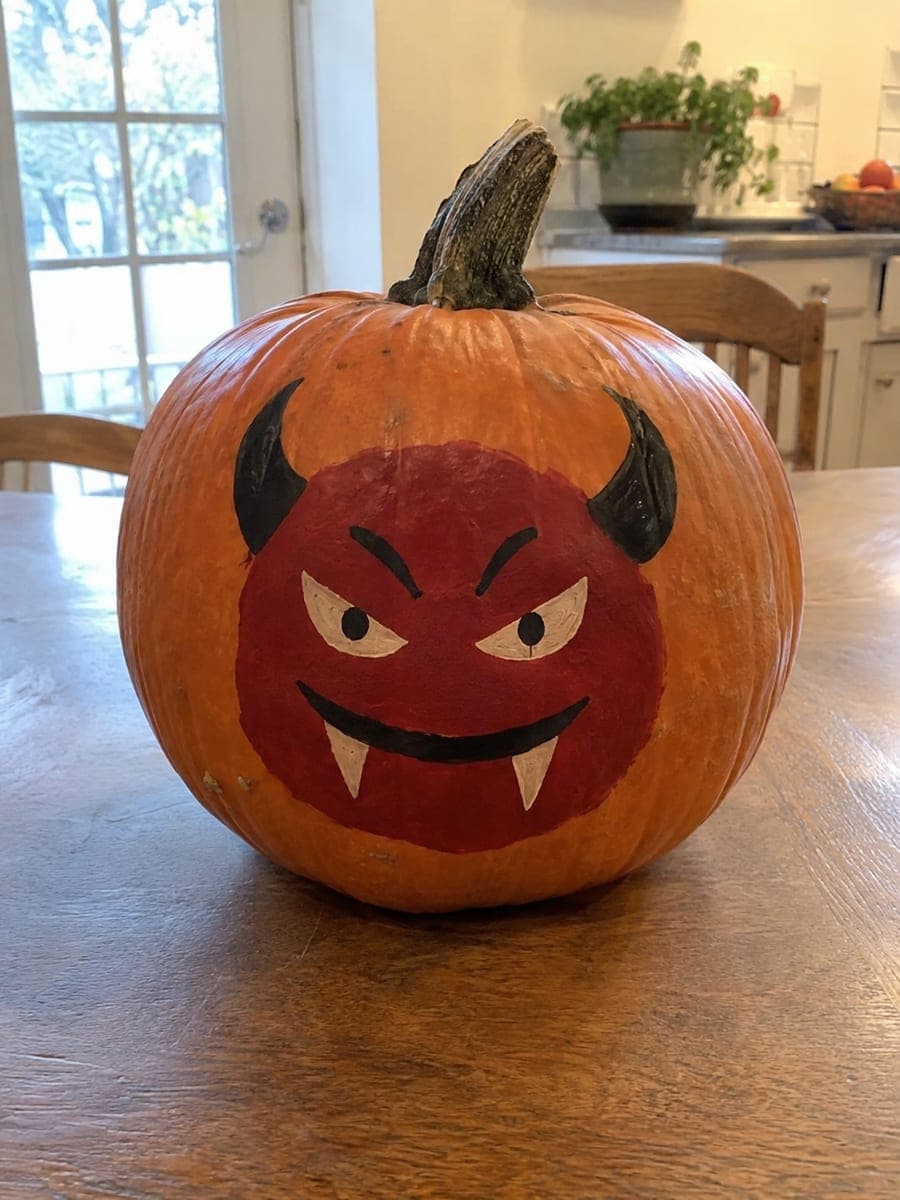 Painted Red Demon Pumpkin with Black Horns and Fangs