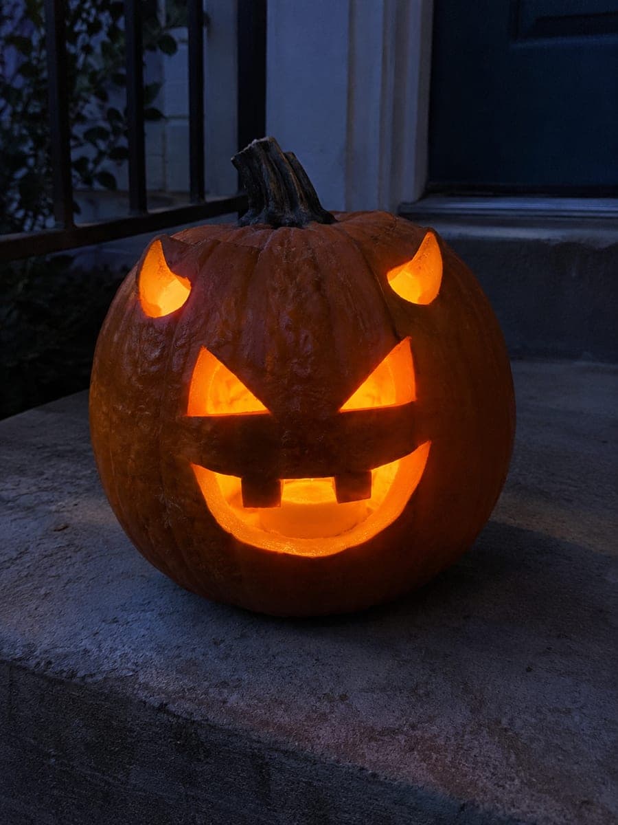 Simple Horned Demon Face Pumpkin on a Doorstep