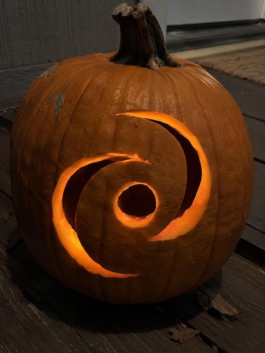 Simple Spiral Galaxy Pumpkin on a Porch at Night