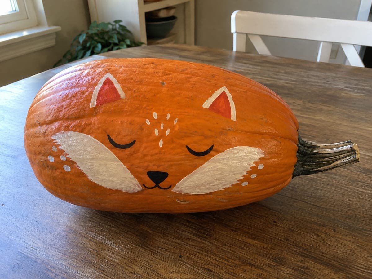 Sleeping Fox Face Sideways Pumpkin on a Kitchen Table