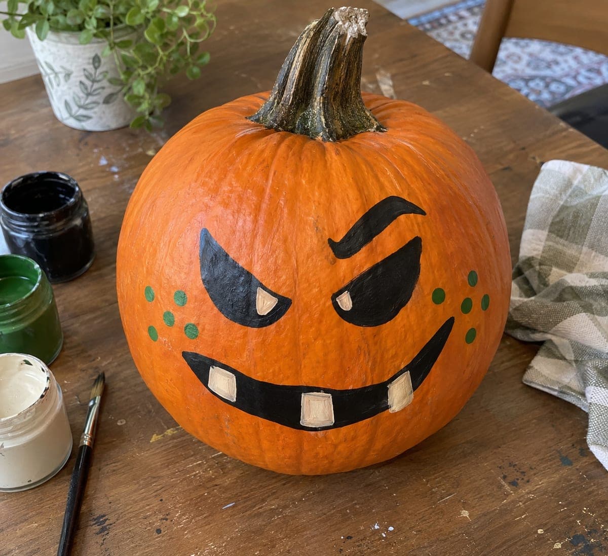 Smirking Painted Pumpkin With Green Freckles