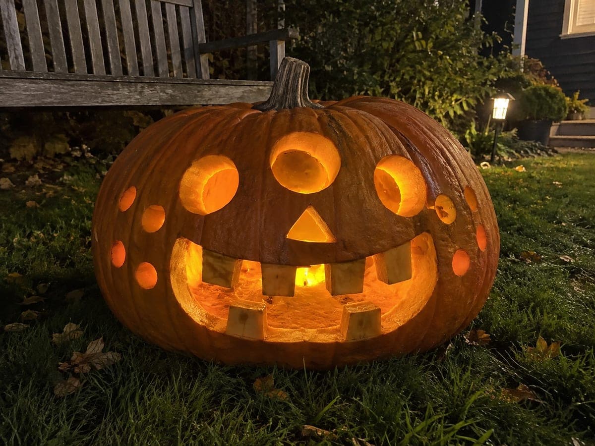 Three-Eyed Monster Giant Pumpkin Glowing on the Lawn