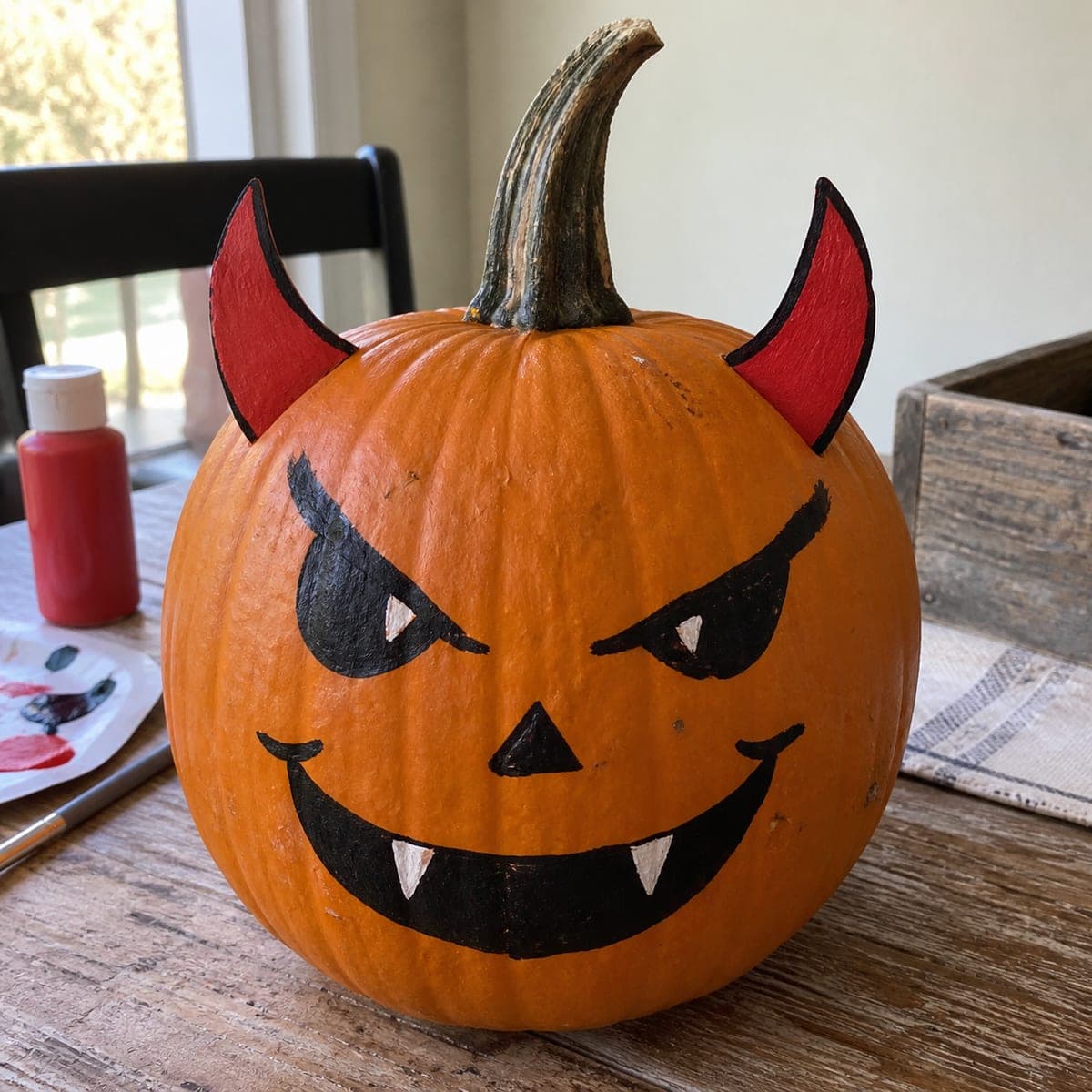 Devil Face Painted Pumpkin With Red Horns